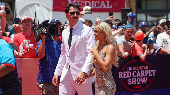 Jul 16, 2024; Pittsburgh Pirates pitcher Paul Skenes walks the red carpet with LSU gymnast and girlfriend Livvy Dunne at Globe Life Field.