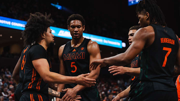 Feb 21, 2026; Charlottesville, Virginia, USA; Miami (FL) Hurricanes forward Malik Reneau (5) and teammates talk during the first half against the Virginia Cavaliers at John Paul Jones Arena. Mandatory Credit: Emily Faith Morgan-Imagn Images