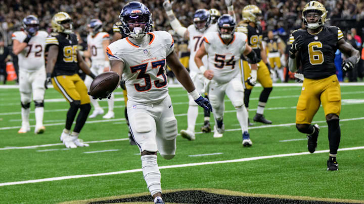 Denver Broncos running back Javonte Williams (33) scores a touchdown against the New Orleans Saints during the second quarter at Caesars Superdome.