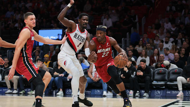 Jan 21, 2025; Miami, Florida, USA; Miami Heat forward Jimmy Butler (22) drives to the basket past Portland Trail Blazers center Deandre Ayton (2) during the first quarter at Kaseya Center. Mandatory Credit: Sam Navarro-Imagn Images