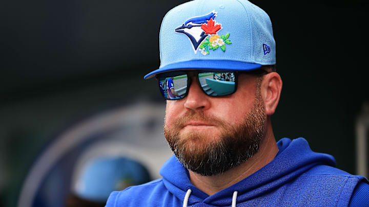 Feb 22, 2026; Fort Myers, Florida, USA; Toronto Blue Jays manager John Schneider (14) looks on during the third inning against the Boston Red Sox  at JetBlue Park at Fenway South.