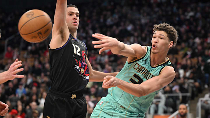Mar 28, 2025; Toronto, Ontario, CAN; Charlotte Hornets forward Tidjane Salaun (31) passes the ball past Toronto Raptors forward Cole Swider (12) in the second half at Scotiabank Arena. Mandatory Credit: Dan Hamilton-Imagn Images Mar 28, 2025; Toronto, Ontario, CAN; Charlotte Hornets forward Tidjane Salaun (31) passes the ball past Toronto Raptors forward Cole Swider (12) in the second half at Scotiabank Arena. Mandatory Credit: Dan Hamilton-Imagn Images