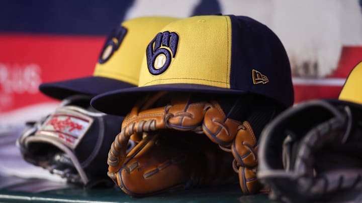 Aug 4, 2025; Atlanta, Georgia, USA; A detailed view of a Milwaukee Brewers hat and glove in the dugout against the Atlanta Braves in the fourth inning at Truist Park. Mandatory Credit: Brett Davis-Imagn Images