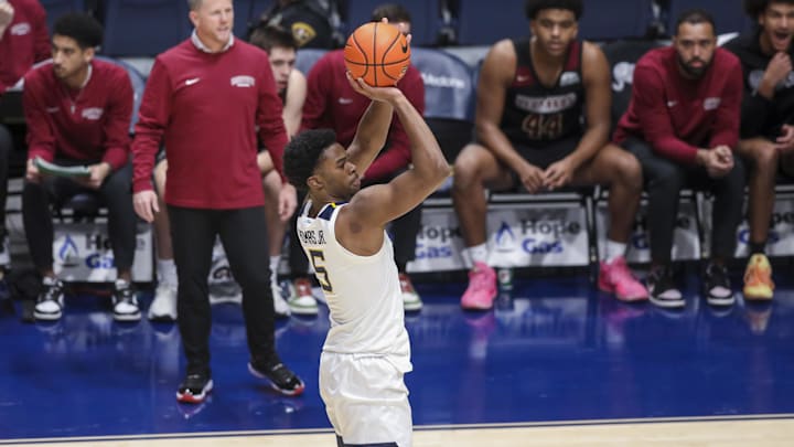 Nov 17, 2025; Morgantown, West Virginia, USA; West Virginia Mountaineers forward DJ Thomas (5) shoots a three-point shot during the first half against the Lafayette Leopards at WVU Coliseum. Mandatory Credit: Ben Queen-Imagn Images