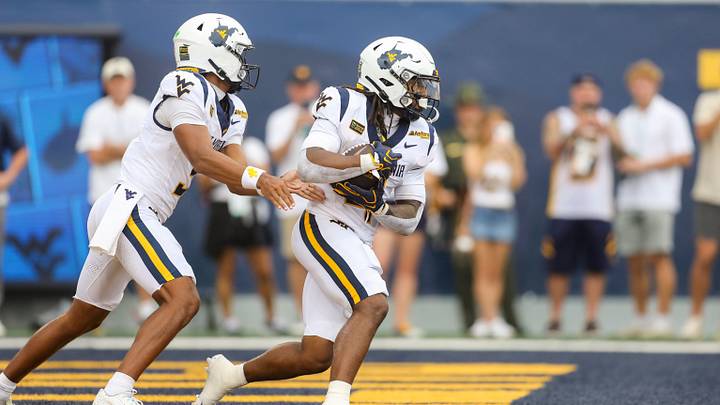 Sep 5, 2026; Morgantown, West Virginia, USA; West Virginia Mountaineers quarterback Michael Hawkins Jr. (3) hands the ball off to West Virginia Mountaineers running back Cam Cook (4) during the first quarter against the Coastal Carolina Chanticleers at Milan Puskar Stadium. Mandatory Credit: Ben Queen-Imagn Images
