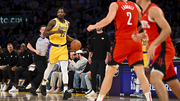 Apr 11, 2025; Los Angeles, California, USA; Los Angeles Lakers forward Dorian Finney-Smith (17) moves the ball against Houston Rockets center Jock Landale (2) during the first half at Crypto.com Arena. Mandatory Credit: Jonathan Hui-Imagn Images