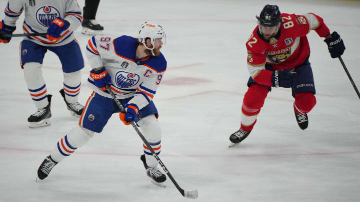 Jun 18, 2024; Sunrise, Florida, USA; Edmonton Oilers forward Connor McDavid (97) controls the puck against Florida Panthers forward Kevin Stenlund (82) during the third period in game five of the 2024 Stanley Cup Final at Amerant Bank Arena. Mandatory Credit: Jim Rassol-USA TODAY Sports