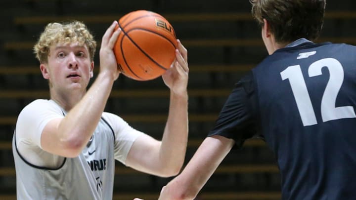 Purdue Boilermakers guard Jack Benter (14) is guarded by center Daniel Jacobsen (12)