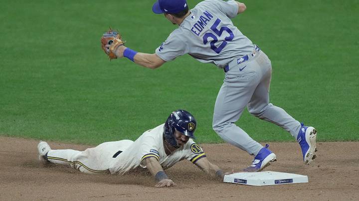Milwaukee Brewers third baseman David Hamilton (6) steals second base as Los Angeles Dodgers second baseman Tommy Edman (25) attempts a tag during the eighth inning of their National League Championship Series game at American Family Field on Oct 12, 2026. Milwaukee Brewers third baseman David Hamilton (6) steals second base as Los Angeles Dodgers second baseman Tommy Edman (25) attempts a tag during the eighth inning of their National League Championship Series game at American Family Field on Oct 12, 2026.