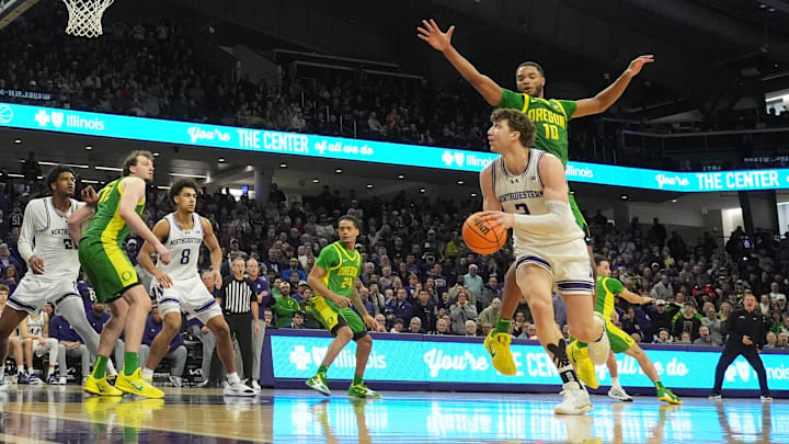 Feb 28, 2026; Evanston, Illinois, USA; Northwestern Wildcats forward Nick Martinelli (2) shoots the game-winning shot as Oregon Ducks forward Kwame Evans Jr. (10) defends him during the second half at Welsh-Ryan Arena. Mandatory Credit: David Banks-Imagn Images