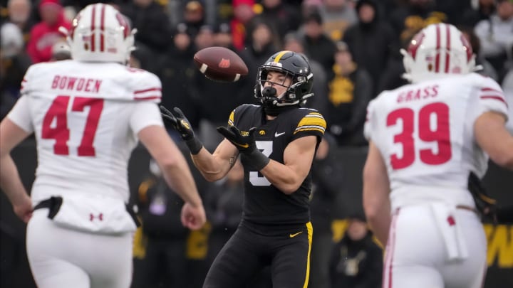 Cooper DeJean catches a punt against Wisconsin.