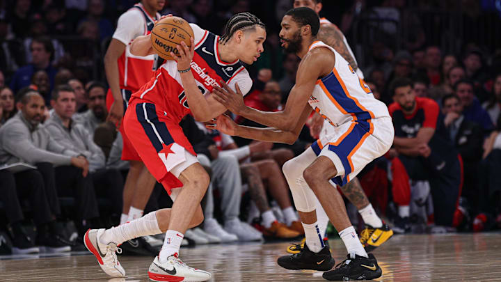 Mar 22, 2025; New York, New York, USA; Washington Wizards forward Kyshawn George (18) is guarded by New York Knicks forward Mikal Bridges (25) during the first half at Madison Square Garden. Mandatory Credit: Vincent Carchietta-Imagn Images