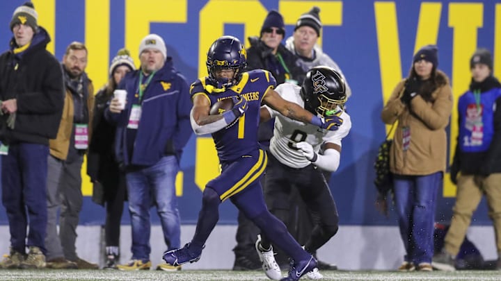 Nov 23, 2024; Morgantown, West Virginia, USA; West Virginia Mountaineers running back Jahiem White (1) runs the ball against the UCF Knights during the third quarter at Mountaineer Field at Milan Puskar Stadium. Mandatory Credit: Ben Queen-Imagn Images
