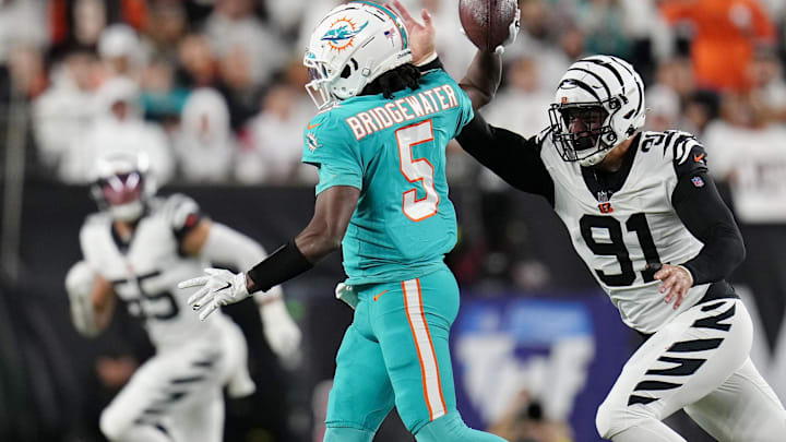 Sep 29, 2022; Cincinnati, Ohio, USA; Cincinnati Bengals defensive end Trey Hendrickson (91) attempts to strip the ball from Miami Dolphins quarterback Teddy Bridgewater (5) as he scrambles in the second quarter at Paycor Stadium. Mandatory Credit: Sam Greene/Cincinnati Enquirer via USA TODAY NETWORK