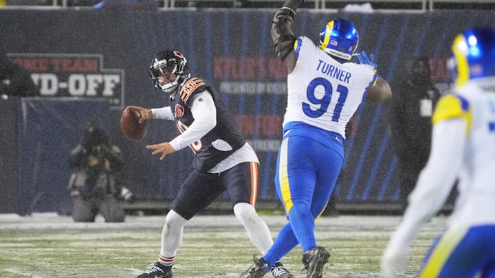 Caleb Williams looks downfield as defensive end Kobie Turner rushes in the third quarter Sunday night.