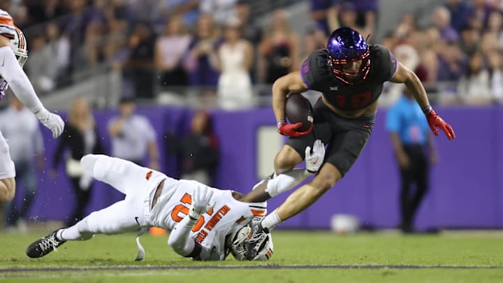Nov 9, 2024; Fort Worth, Texas, USA; TCU Horned Frogs wide receiver Jack Bech (18) is tackled by Oklahoma State Cowboys safety David Kabongo (18) in the first quarter at Amon G. Carter Stadium. Mandatory Credit: Tim Heitman-Imagn Images