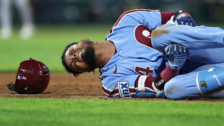 Sep 24, 2026; Philadelphia, Pennsylvania, USA; Philadelphia Phillies second baseman Luis Arraez (4) grabs his leg with an apparent injury while running to first base during the sixth inning against the Milwaukee Brewers at Citizens Bank Park. Mandatory Credit: Bill Streicher-Imagn Images