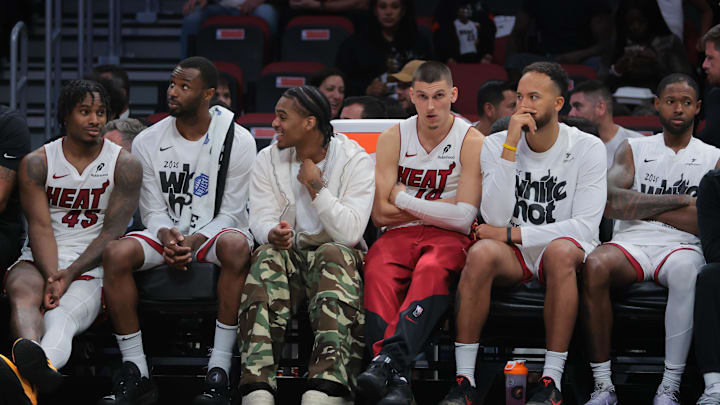 Apr 28, 2025; Miami, Florida, USA; Miami Heat guard Tyler Herro (center) looks on from the bench against the Cleveland Cavaliers in the fourth quarter during game four for the first round of the 2025 NBA Playoffs at Kaseya Center. Mandatory Credit: Sam Navarro-Imagn Images