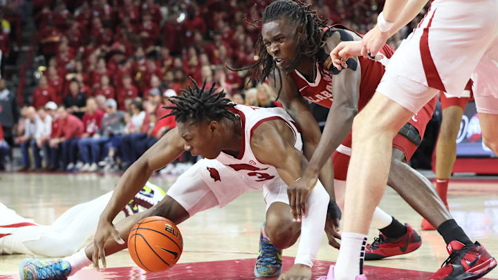 Alabama Crimson Tide center Clifford Omoruyi (11) and Arkansas Razorbacks forward Adou Thiero (3) fight for a loose ball in the second half at Bud Walton Arena. Alabama won 85-81. 