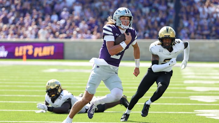 Sep 27, 2025; Manhattan, Kansas, USA; Kansas State Wildcats quarterback Avery Johnson (2) runs away from UCF Knights defensive back Phillip Dunnam (2) and UCF Knights defensive end Malchi Lawrence (51) during the second quarter at Bill Snyder Family Football Stadium. Mandatory Credit: Scott Sewell-Imagn Images Sep 27, 2025; Manhattan, Kansas, USA; Kansas State Wildcats quarterback Avery Johnson (2) runs away from UCF Knights defensive back Phillip Dunnam (2) and UCF Knights defensive end Malchi Lawrence (51) during the second quarter at Bill Snyder Family Football Stadium. Mandatory Credit: Scott Sewell-Imagn Images