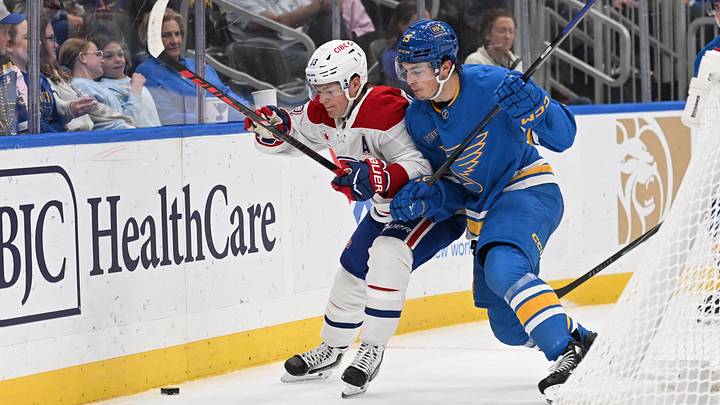Oct 27, 2026; St. Louis, Missouri, USA;  Montreal Canadiens right wing Cole Caufield (13) and St. Louis Blues right wing Dalibor Dvorsky (15) battle for the puck in the first period at Enterprise Center.  Mandatory Credit: Joe Puetz-Imagn Images