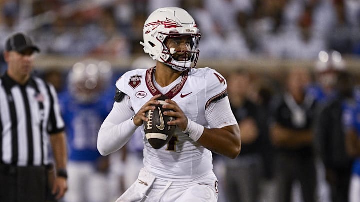 Sep 28, 2024; Dallas, Texas, USA; Florida State Seminoles quarterback DJ Uiagalelei (4) rolls back to pass against the Southern Methodist Mustangs during the second quarter at Gerald J. Ford Stadium. Mandatory Credit: Jerome Miron-Imagn Images