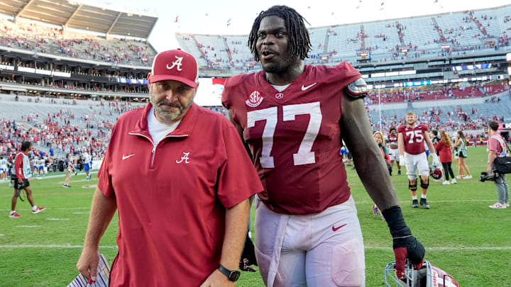 Nov 22, 2025; Tuscaloosa, Alabama, USA; Offensive line coach Chris Kapilovic walks of the field with Alabama senior offensive lineman Jaeden Roberts (77) at Saban Field at Bryant-Denny Stadium. Mandatory Credit: Gary Cosby Jr.-Imagn Images Nov 22, 2025; Tuscaloosa, Alabama, USA; Offensive line coach Chris Kapilovic walks of the field with Alabama senior offensive lineman Jaeden Roberts (77) at Saban Field at Bryant-Denny Stadium. Mandatory Credit: Gary Cosby Jr.-Imagn Images