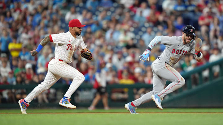Philadelphia, Pennsylvania, USA; Philadelphia Phillies infielder Edmundo Sosa (33) runs down Boston Red Sox infielder Trevor Story (10) in the tenth inning at Citizens Bank Park.