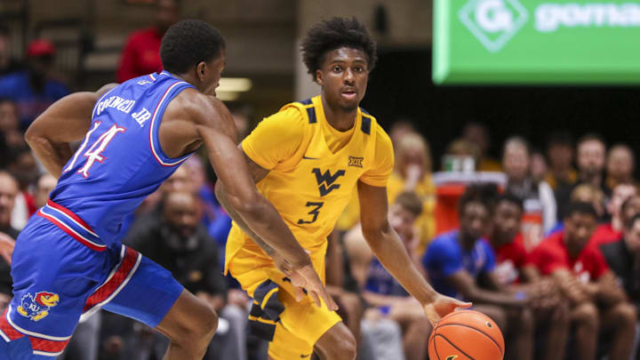 Jan 10, 2026; Morgantown, West Virginia, USA; West Virginia Mountaineers guard Honor Huff (3) dribbles against Kansas Jayhawks guard Melvin Council Jr. (14) during the second half at Hope Coliseum. 