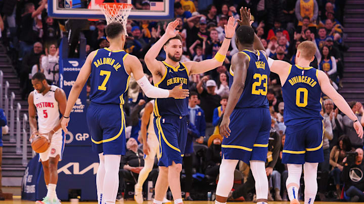 Jan 4, 2023; San Francisco, California, USA; Golden State Warriors shooting guard Klay Thompson (11) celebrates with small forward Patrick Baldwin (7), power forward Draymond Green (23) and shooting guard Donte DiVincenzo (0) after a play against the Detroit Pistons during the fourth quarter at Chase Center. Mandatory Credit: Kelley L Cox-Imagn Images