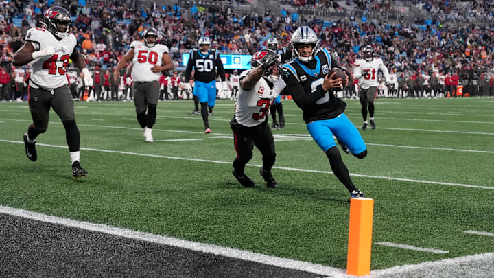 Dec 1, 2024; Charlotte, North Carolina, USA; Carolina Panthers quarterback Bryce Young (9) scores a touchdown as Tampa Bay Buccaneers safety Antoine Winfield Jr. (31) defends in the second quarter at Bank of America Stadium. Mandatory Credit: Bob Donnan-Imagn Images Dec 1, 2024; Charlotte, North Carolina, USA; Carolina Panthers quarterback Bryce Young (9) scores a touchdown as Tampa Bay Buccaneers safety Antoine Winfield Jr. (31) defends in the second quarter at Bank of America Stadium. Mandatory Credit: Bob Donnan-Imagn Images