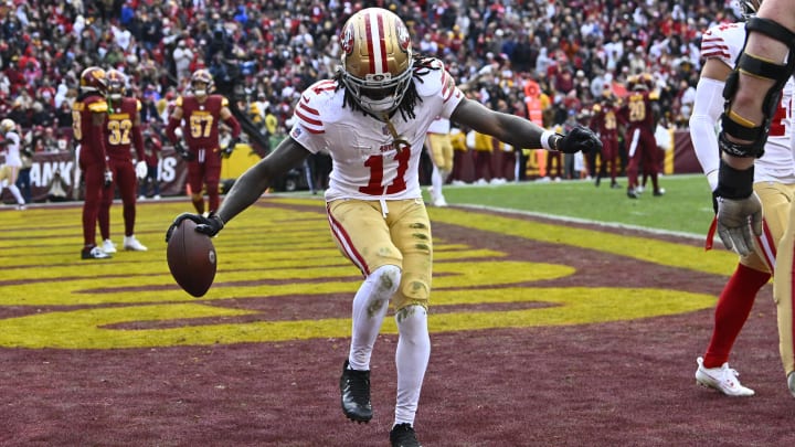 Dec 31, 2023; Landover, Maryland, USA; San Francisco 49ers wide receiver Brandon Aiyuk (11) celebrates after scoring a touchdown against the Washington Commanders during the second half at FedExField. Mandatory Credit: Brad Mills-USA TODAY Sports Dec 31, 2023; Landover, Maryland, USA; San Francisco 49ers wide receiver Brandon Aiyuk (11) celebrates after scoring a touchdown against the Washington Commanders during the second half at FedExField. Mandatory Credit: Brad Mills-USA TODAY Sports