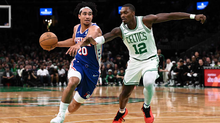 Oct 12, 2024; Boston, Massachusetts, USA; Philadelphia 76ers guard Jared McCain (20) drives to the basket against Boston Celtics guard Lonnie Walker IV (12) during the first half at the TD Garden. Mandatory Credit: Brian Fluharty-Imagn Images