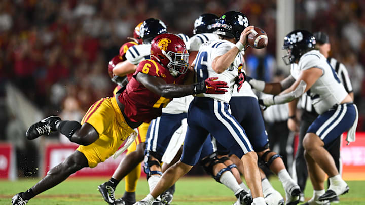Sep 7, 2024; Los Angeles, California, USA; USC Trojans defensive end Anthony Lucas (6) attempts to sack Utah State Aggies quarterback Bryson Barnes (16) during the second quarter at United Airlines Field at Los Angeles Memorial Coliseum. Sep 7, 2024; Los Angeles, California, USA; USC Trojans defensive end Anthony Lucas (6) attempts to sack Utah State Aggies quarterback Bryson Barnes (16) during the second quarter at United Airlines Field at Los Angeles Memorial Coliseum.