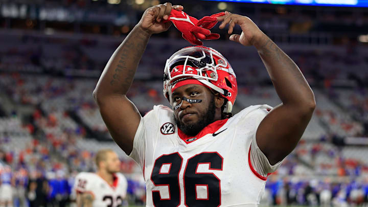 Georgia Bulldogs defensive lineman Zion Logue (96) pumps up the crowd