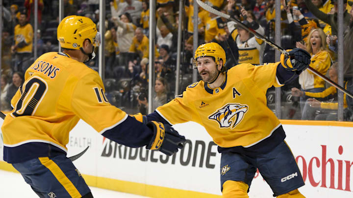 Mar 6, 2025; Nashville, Tennessee, USA;  Nashville Predators left wing Filip Forsberg (9) celebrates his goal with center Colton Sissons (10) against the Seattle Kraken during the first period at Bridgestone Arena. Mandatory Credit: Steve Roberts-Imagn Images