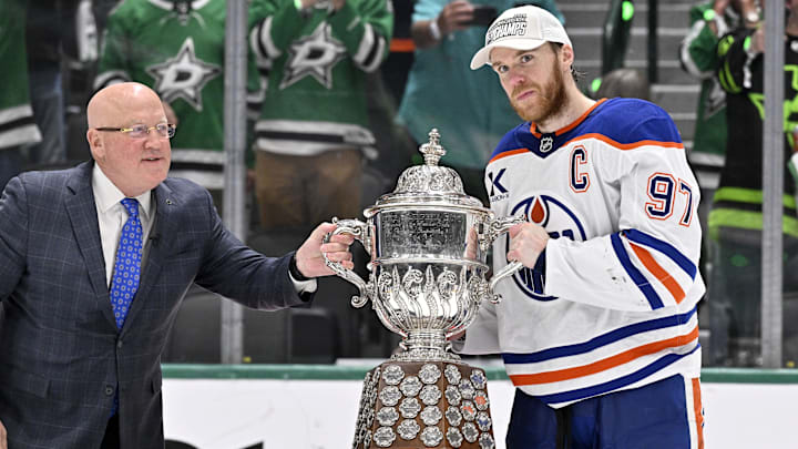 NHL deputy commissioner Bill Daly and Edmonton Oilers center Connor McDavid (97) pose with the trophy after winning the Western Conference Final