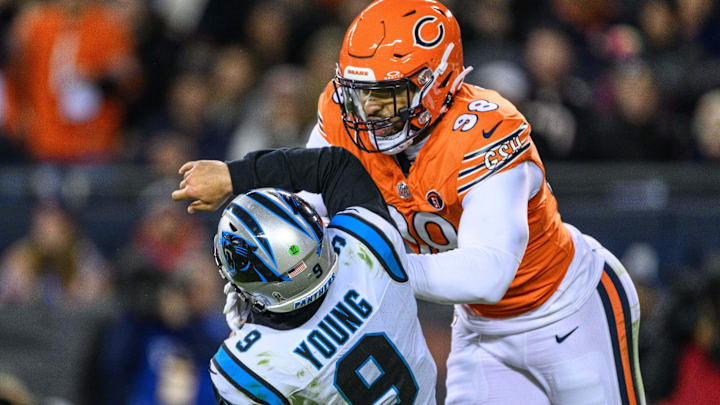 Bryce Young gets knocked to the turf by Montez Sweat in a 2023 Bears win over Carolina.