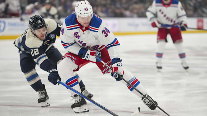 Feb 8, 2025; Columbus, Ohio, USA; New York Rangers right wing Arthur Kaliyev (34) skates with the puck against Columbus Blue Jackets defenseman Jordan Harris (22) in the first period at Nationwide Arena. Mandatory Credit: Aaron Doster-Imagn Images