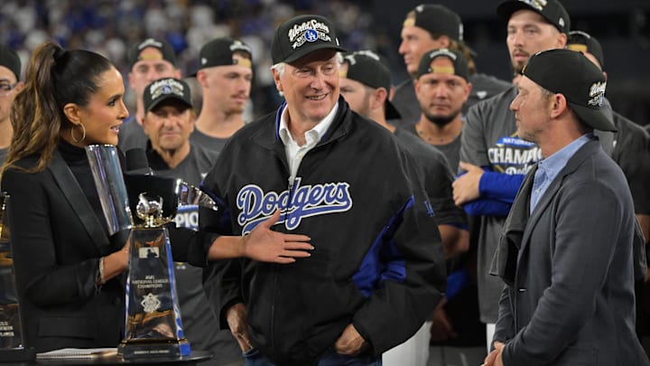Oct 17, 2025; Los Angeles, California, USA; Lauren Shehadi interviews Dodgers owner Mark Walter (center) and president of baseball operations Andrew Friedman (right) after defeating the Milwaukee Brewers in game four of the NLCS round for the 2025 MLB playoffs at Dodger Stadium. Mandatory Credit: Jayne Kamin-Oncea-Imagn Images Oct 17, 2025; Los Angeles, California, USA; Lauren Shehadi interviews Dodgers owner Mark Walter (center) and president of baseball operations Andrew Friedman (right) after defeating the Milwaukee Brewers in game four of the NLCS round for the 2025 MLB playoffs at Dodger Stadium. Mandatory Credit: Jayne Kamin-Oncea-Imagn Images