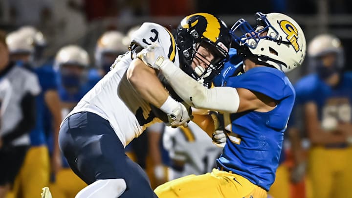 Germantown linebacker Jon Murkowski (41) brings down Marquette running back Jack Dorley (3) in a Greater Metro Conference game Friday, September 13, 2024.