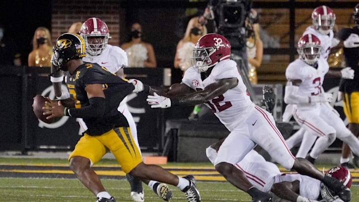 Sep 26, 2020; Columbia, Missouri, USA; Missouri Tigers quarterback Shawn Robinson (3) scrambles as Alabama Crimson Tide linebacker Dylan Moses (32) attempts the tackle during the game at Faurot Field at Memorial Stadium. Mandatory Credit: Denny Medley-Imagn Images