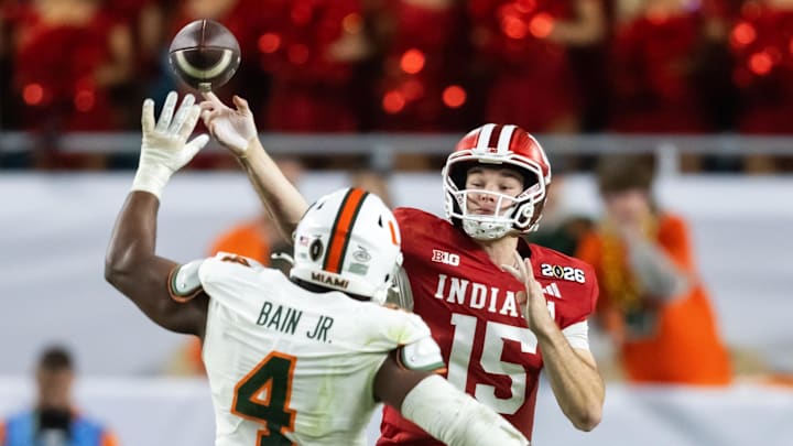 Jan 19, 2026; Miami Gardens, FL, USA; Miami Hurricanes defensive lineman Rueben Bain Jr. (4) defends against Indiana Hoosiers quarterback Fernando Mendoza (15) during the College Football Playoff National Championship game at Hard Rock Stadium. Mandatory Credit: Mark J. Rebilas-Imagn Images Jan 19, 2026; Miami Gardens, FL, USA; Miami Hurricanes defensive lineman Rueben Bain Jr. (4) defends against Indiana Hoosiers quarterback Fernando Mendoza (15) during the College Football Playoff National Championship game at Hard Rock Stadium. Mandatory Credit: Mark J. Rebilas-Imagn Images
