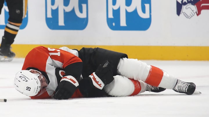 Feb 27, 2025; Pittsburgh, Pennsylvania, USA;  Philadelphia Flyers right wing Garnet Hathaway (19) lays on the ice after suffering an apparent injury after being hit by Pittsburgh Penguins left wing Bokondji Imama (not pictured) during the second period at PPG Paints Arena. Mandatory Credit: Charles LeClaire-Imagn Images