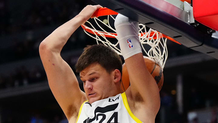 Nov 2, 2024; Denver, Colorado, USA; Utah Jazz center Walker Kessler (24) finishes off a basket in the first half against the Denver Nuggets at Ball Arena. Mandatory Credit: Ron Chenoy-Imagn Images