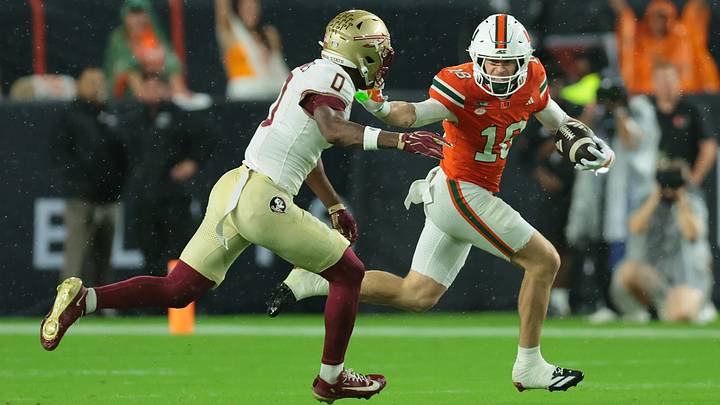 Oct 17, 2026; Miami Gardens, Florida, USA; Miami Hurricanes wide receiver Cooper Barkate (18) runs against
Florida State Seminoles defensive back Quindarrius Jones (0) during the first quarter at Hard Rock Stadium. Mandatory Credit: Sam Navarro-Imagn Images Oct 17, 2026; Miami Gardens, Florida, USA; Miami Hurricanes wide receiver Cooper Barkate (18) runs against
Florida State Seminoles defensive back Quindarrius Jones (0) during the first quarter at Hard Rock Stadium. Mandatory Credit: Sam Navarro-Imagn Images