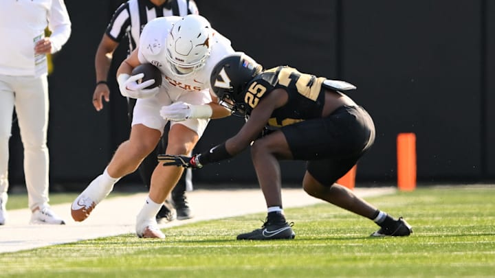 Oct 26, 2024; Nashville, Tennessee, USA;  Vanderbilt Commodores cornerback Martel Hight (25) tackles Texas Longhorns tight end Gunnar Helm (85) after a made catch during the first half at FirstBank Stadium. Mandatory Credit: Steve Roberts-Imagn Images