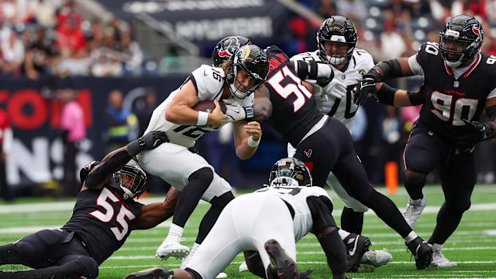 Nov 9, 2025; Houston, Texas, USA;Jacksonville Jaguars quarterback Trevor Lawrence (16) is sacked by Houston Texans defensive end Danielle Hunter (55) in the second half at NRG Stadium. Mandatory Credit: Thomas Shea-Imagn Images