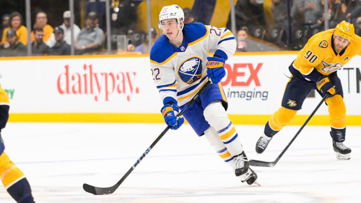Feb 8, 2025; Nashville, Tennessee, USA;  Buffalo Sabres right wing Jack Quinn (22) skates with the puck against the Nashville Predators during the second period at Bridgestone Arena. Mandatory Credit: Steve Roberts-Imagn Images
