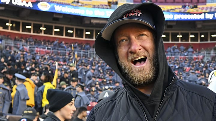 Dec 14, 2024; Landover, Maryland, USA;   Dave Portnoy, Bar Stool Sports  founder and owner  walks along the sidelines before the playing of the 125 Army Navy game at Commanders Field. Mandatory Credit: Tommy Gilligan-Imagn Images

Dec 14, 2024; Landover, Maryland, USA;  Dave Portnoy poses with solders before the between the Army Black Knights and the Navy Midshipmen  at Commanders Field. Mandatory Credit: Tommy Gilligan-Imagn Images